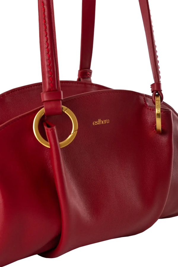 Bolsa baguette em couro legítimo na cor vermelha merlot com fechamento por zíper e alça de ombro confortável, design sofisticado e funcional ideal para o dia a dia.