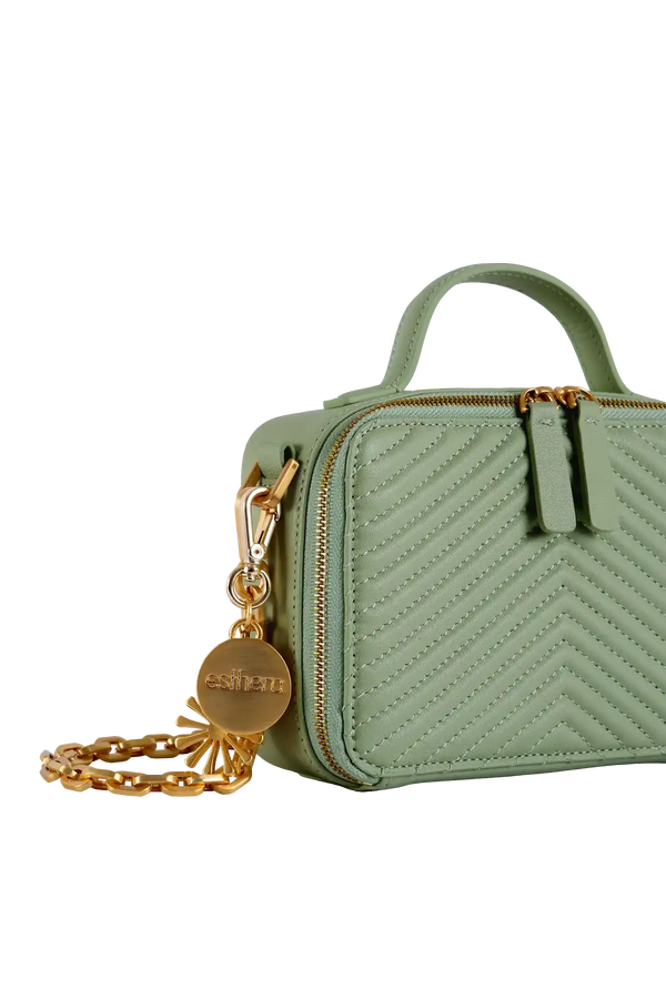 Bolsa verde com costura em zig-zag e detalhes dourados, ideal para acessórios e uso diário.