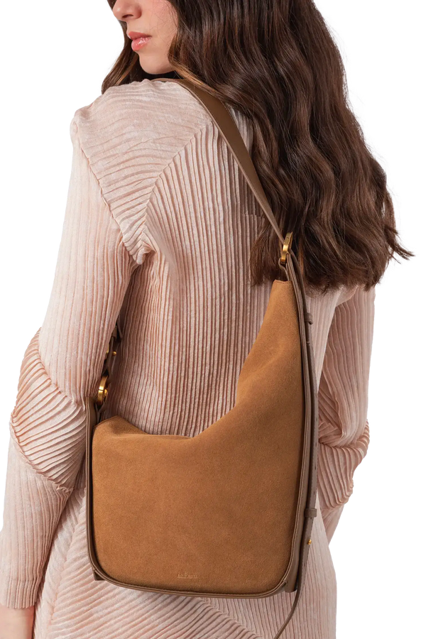 Bolsa em camurça na cor com tom elegante com fechamento por zíper e alça de ombro confortável, design sofisticado e funcional ideal para o dia a dia.